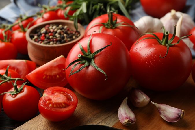 Composition with tomatoes on wooden background. Ripe vegetable