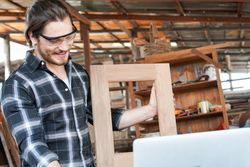 Smiling man with picture frame he made