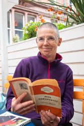 Older woman with short hair reading Miss Hargreaves