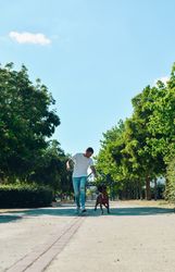 Man running and playing with his dog.