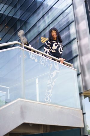 Female artist looking down from terrace
