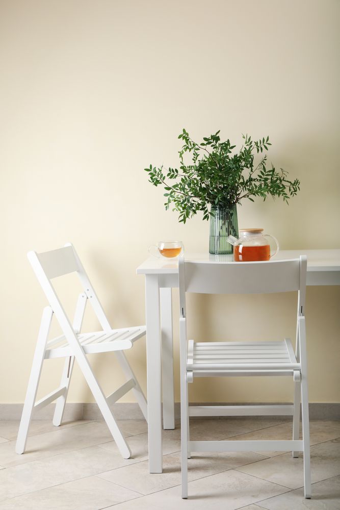 kitchen table with tea and plant in bright room