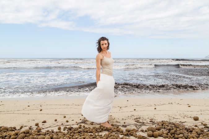 Charming young woman on shore near water