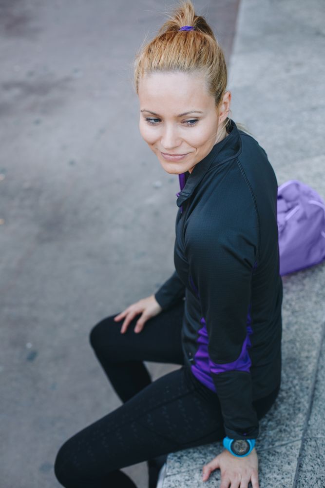 Woman in sportswear sitting outside