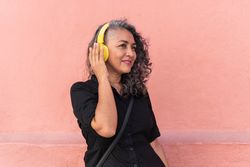 Grey-Haired Woman Listening To Music And Dancing