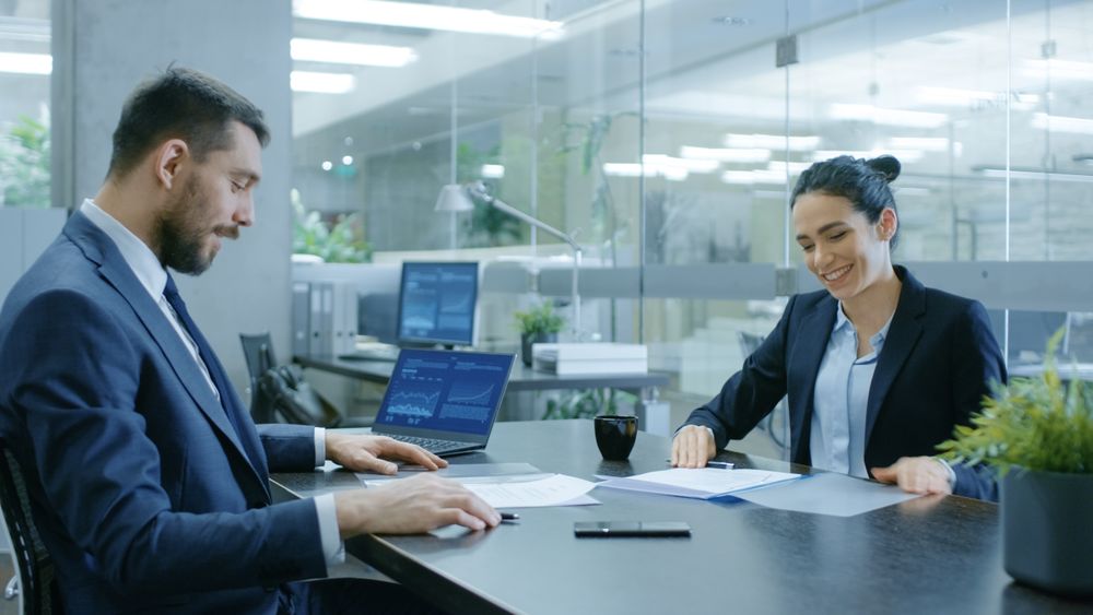 Businesswoman and Businessman Have Conversation.