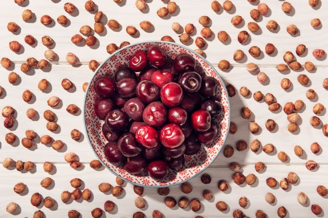 Fresh sweet cherries in bowl and cherry seeds