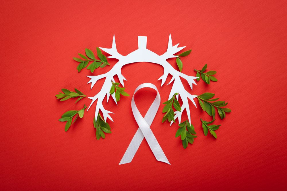 Lung bronchus on red background with ribbon and foliage