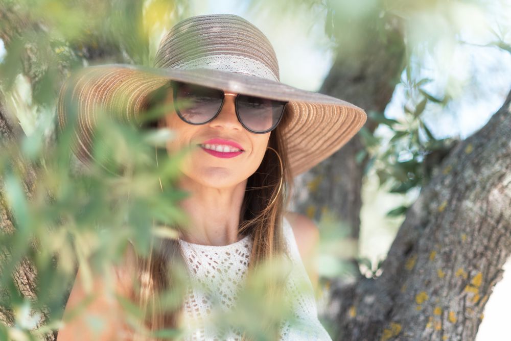 Adult woman smiling near tree