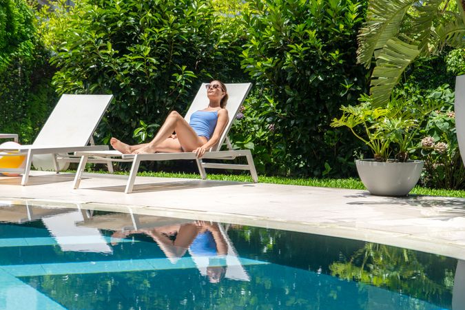 woman relaxing by the pool at a luxury hotel