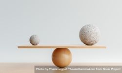Spheres being balanced on wooden scale 47oRA4