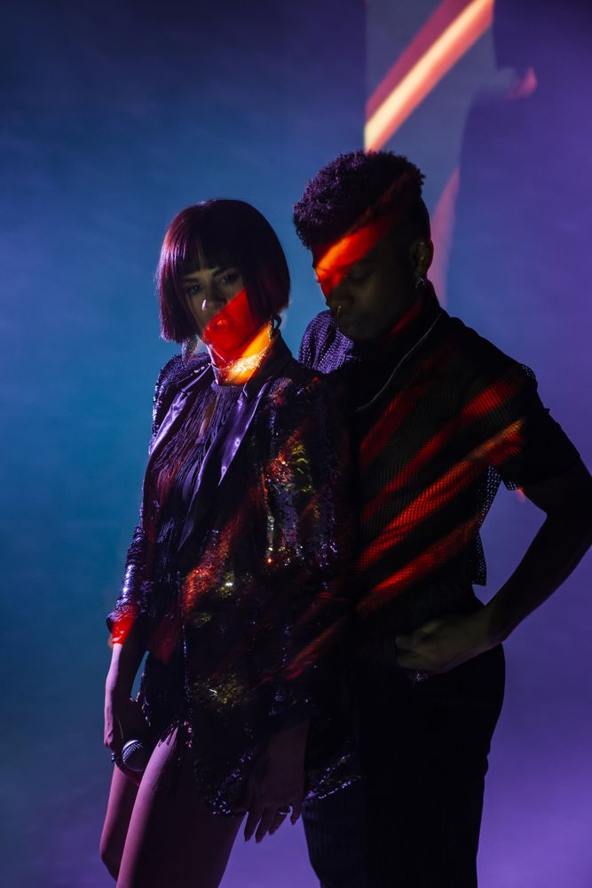 Sensual young dancers near smoke