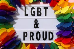 LGBT parade concept, holiday symbols on pink background.