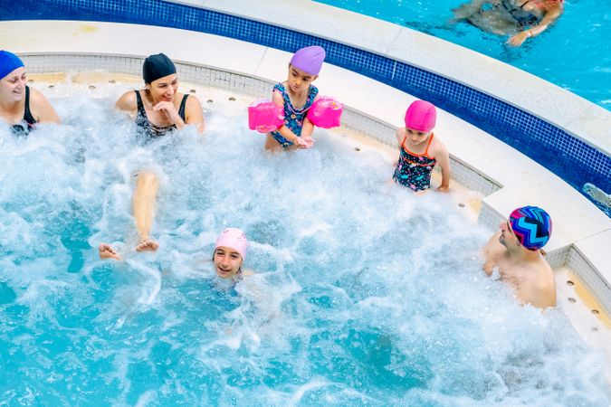 Family relaxing in bubbling pool