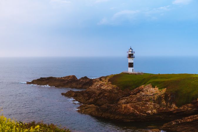 Amazing lighthouse on cliff near sea