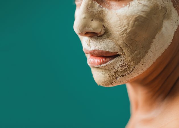 Crop female with dry clay mask