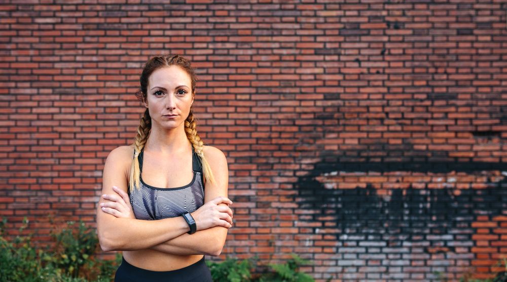 Sportswoman with crossed arms posing