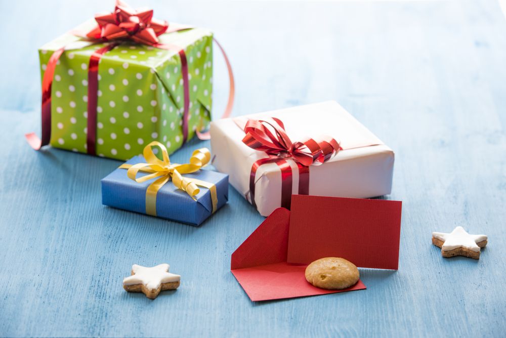 Opened envelope and gifts on blue table