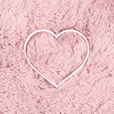 Heart or love symbol with pink fur background