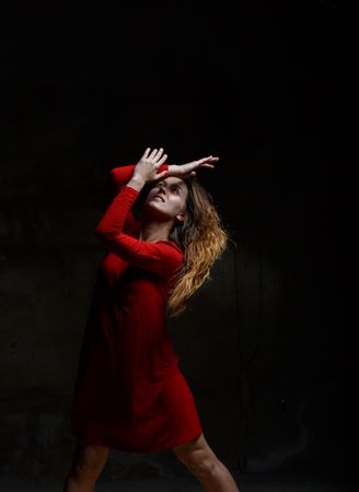 Young woman dancing in darkness