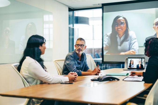 Businesspeople having a virtual meeting in a boardroom