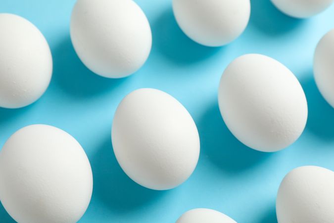Flat lay composition with chicken eggs on color background, space for text