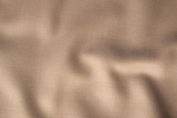 Wavy smooth pattern brown fabric background texture.