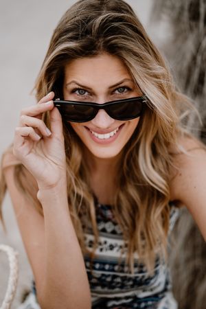 Portrait of young cheerful woman with sunglasses