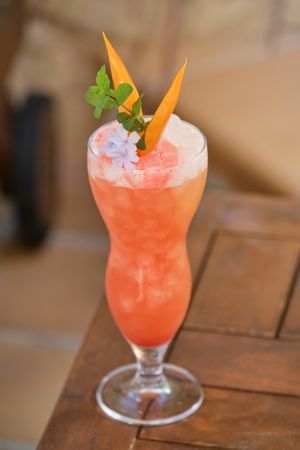 Glass of cocktail with ice cubes