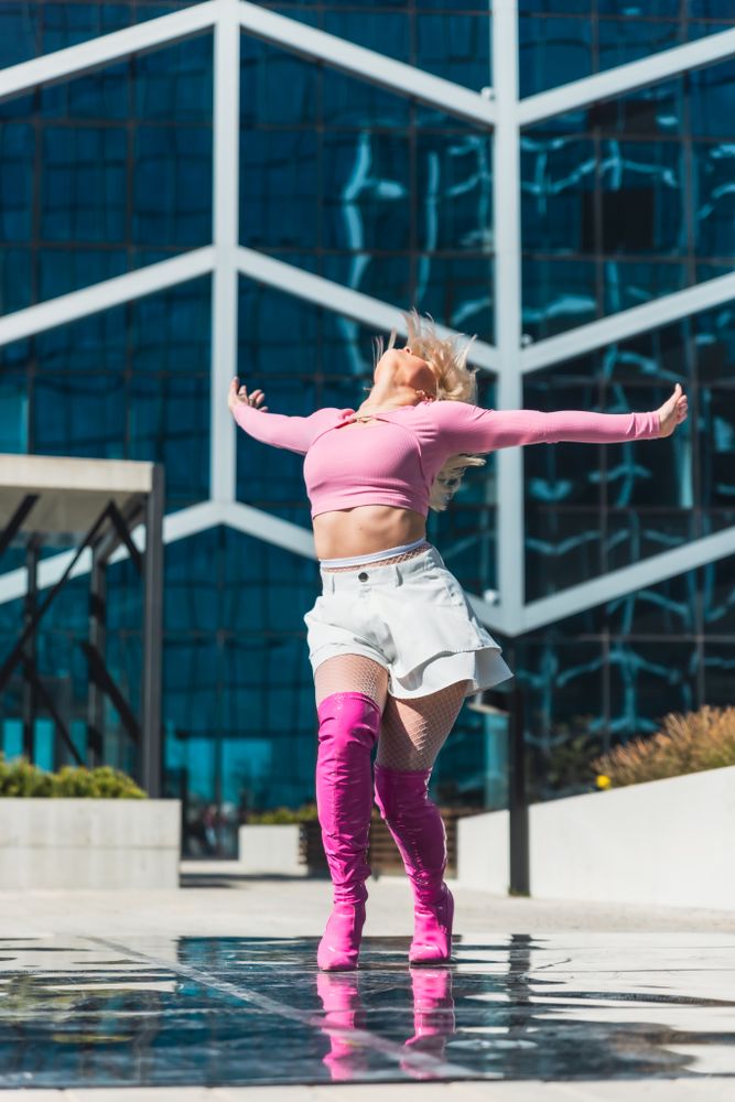 Professional Vogue Dancer Practicing Choreography In Urban Environment During The Day.