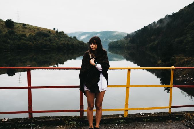 Woman standing looking amazing lake near mountains