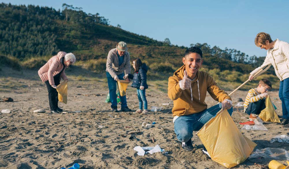 Young man cleaning the beach
