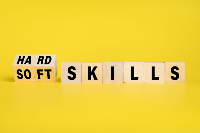 flip wooden blocks with hard and soft skills isolated on yellow background