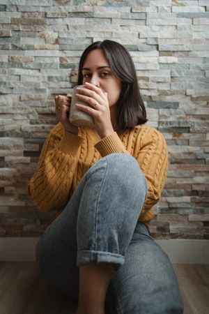 Woman drinking hot tea at home