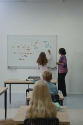 Back view of students and teacher in classroom 49xvE5