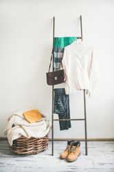 Woolen sweater, checked scarf, jeans, boots, shoulder bag and knitted hat, copy space