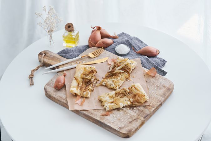 Served onion tart on cutting board