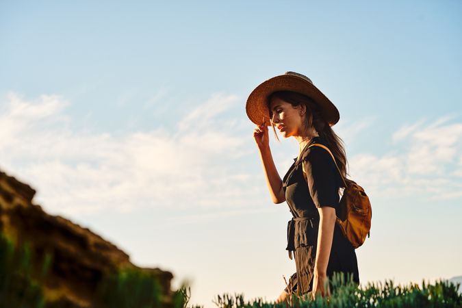 Woman traveler in straw hat walking