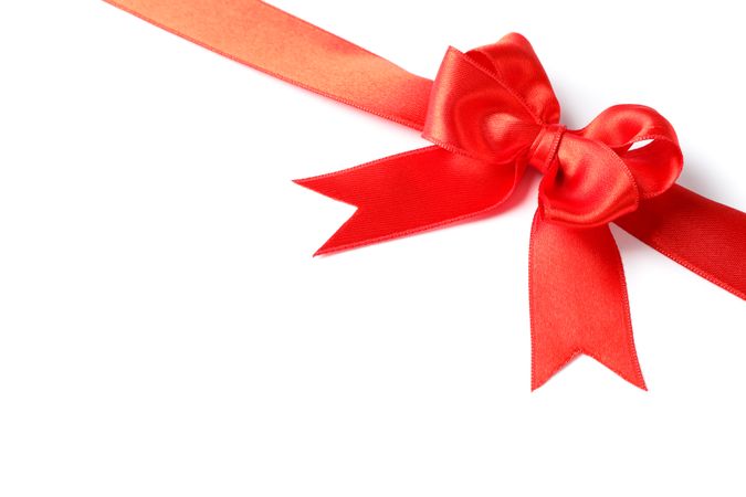 Red ribbon with bow isolated on plain background. Gift concept