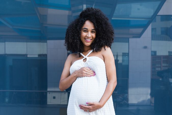 Smiling pregnant woman in long dress