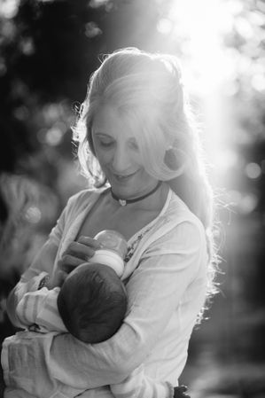 woman feeding a baby with a bottle