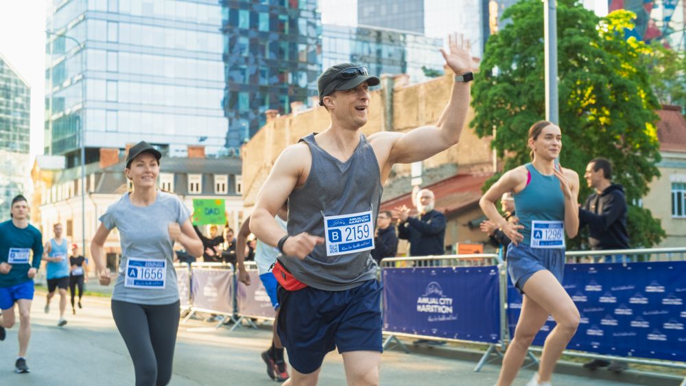 Friendly Happy Male Runner Celebrating Crossing the Finish Line in a Race