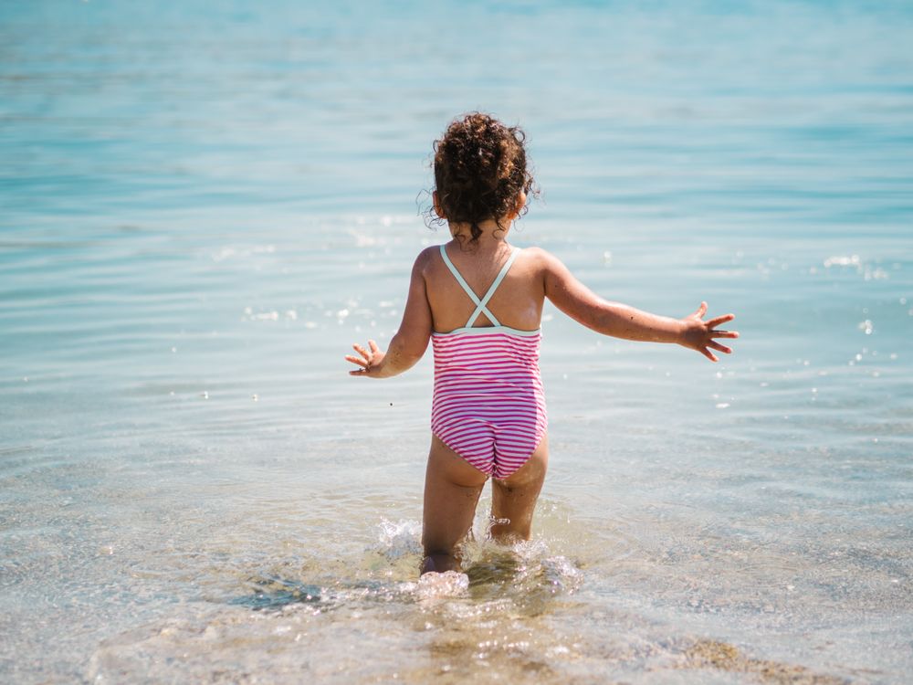 Cheerful girl having fun in warm sea
