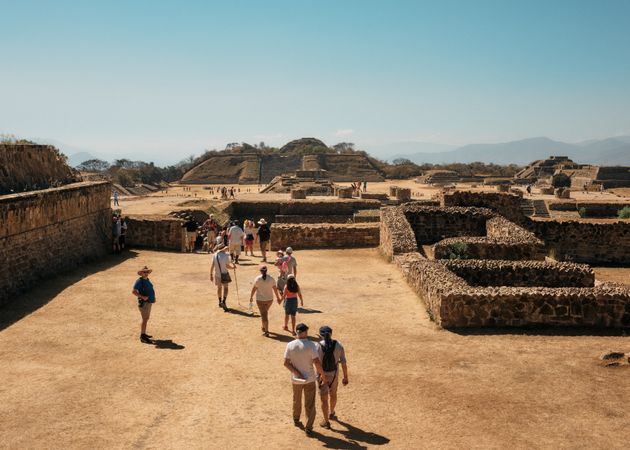 Line of tourist walking towards ruins outside of Oaxaca