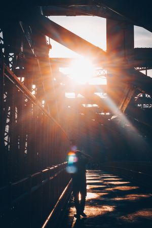 Silhouette of person on bridge during golden hours
