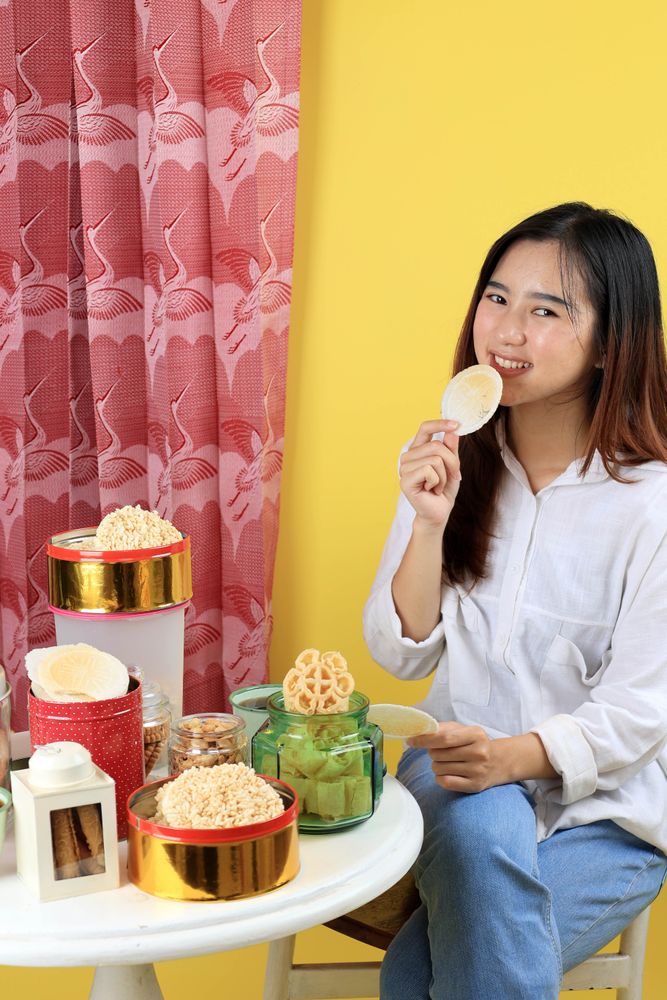 Young Woman Eating Traditional Snack Popular for Eid Al Fitr