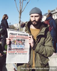 London, England, United Kingdom - March 19 2022: Man holding newspaper saying “Fight Racism" 0LOnDb