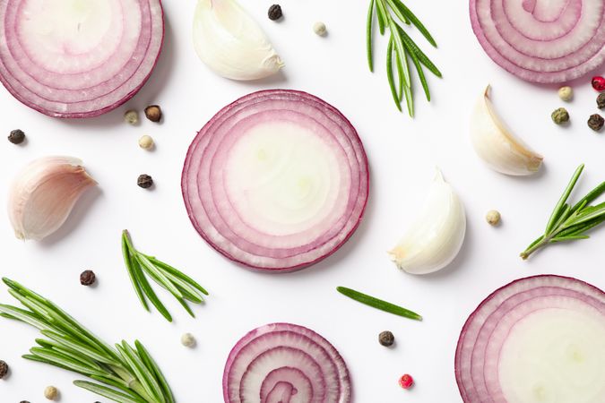 Flat lay composition with red onion rings and spices on neutral background