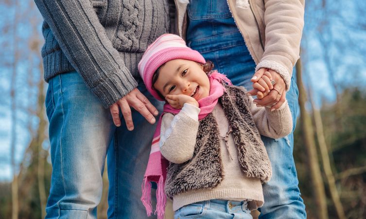 Cute little girl in forest with her parents