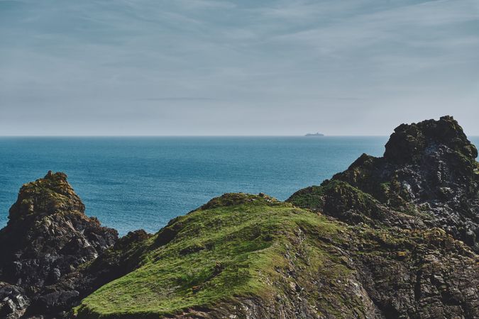 View of the sea from the cliffs with a large ships in the distance